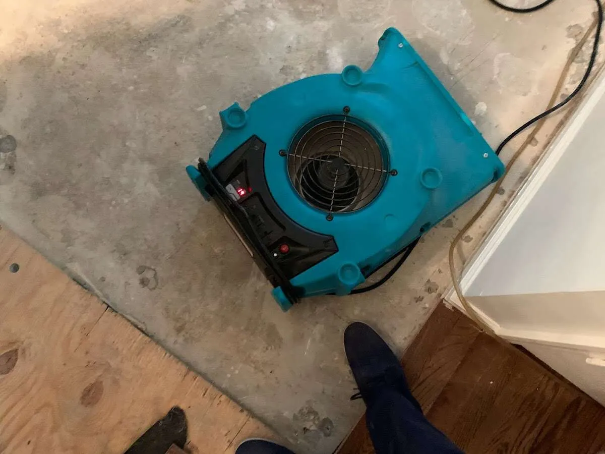 Air mover drying subfloor during Leak Detection & Repair in Carthage